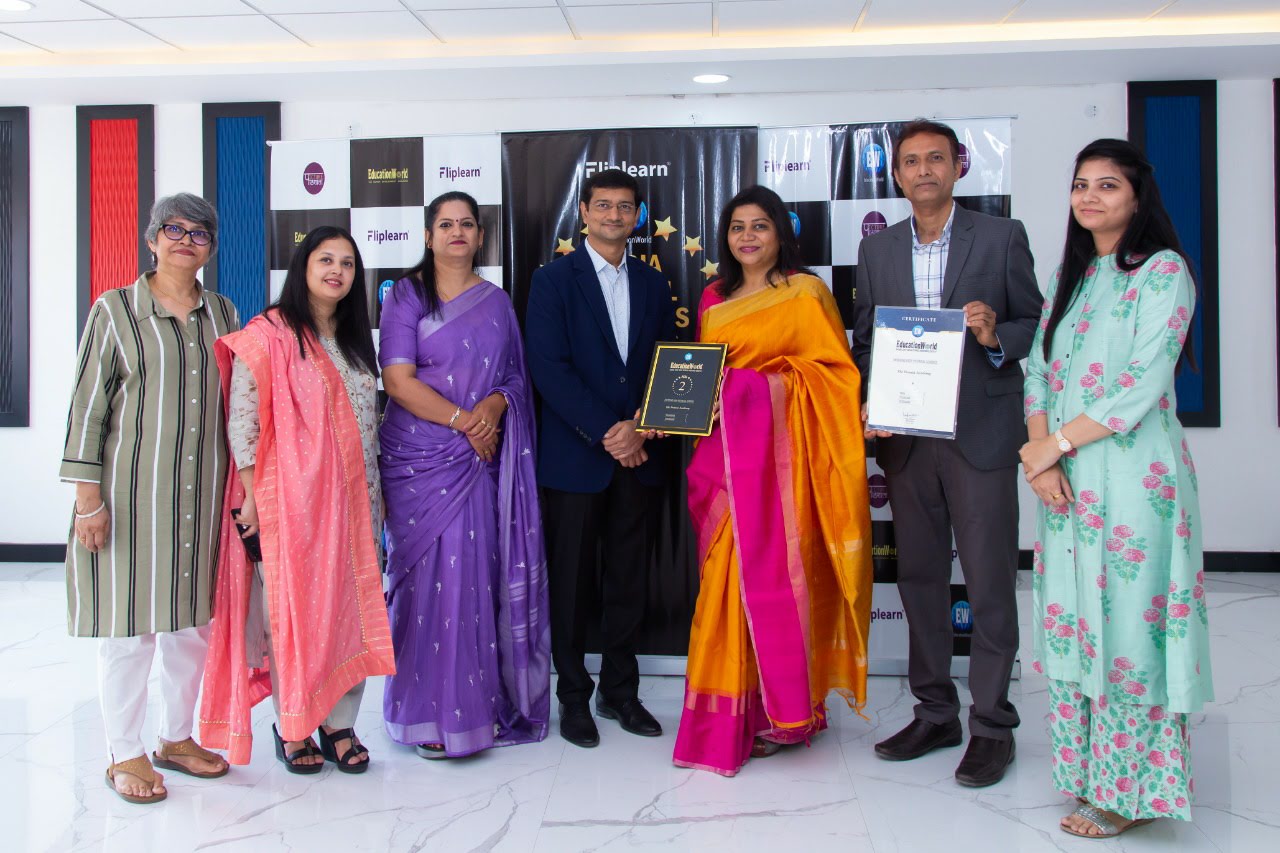 Premia Academy faculty and leadership receiving an educational excellence award from FactoLearn/FlipLearn.