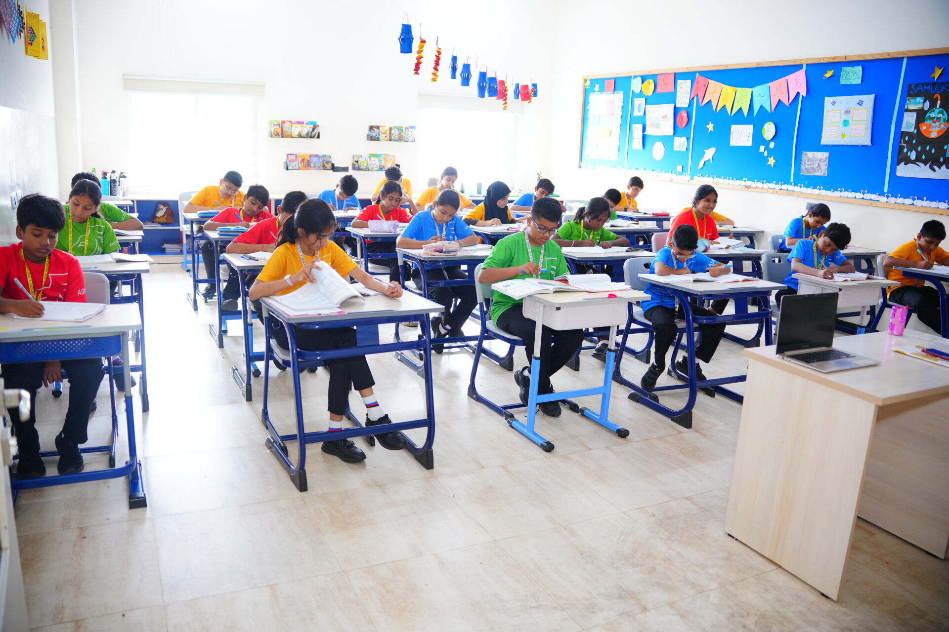Premia Academy students concentrating on their work while taking a test or exam in a modern classroom.