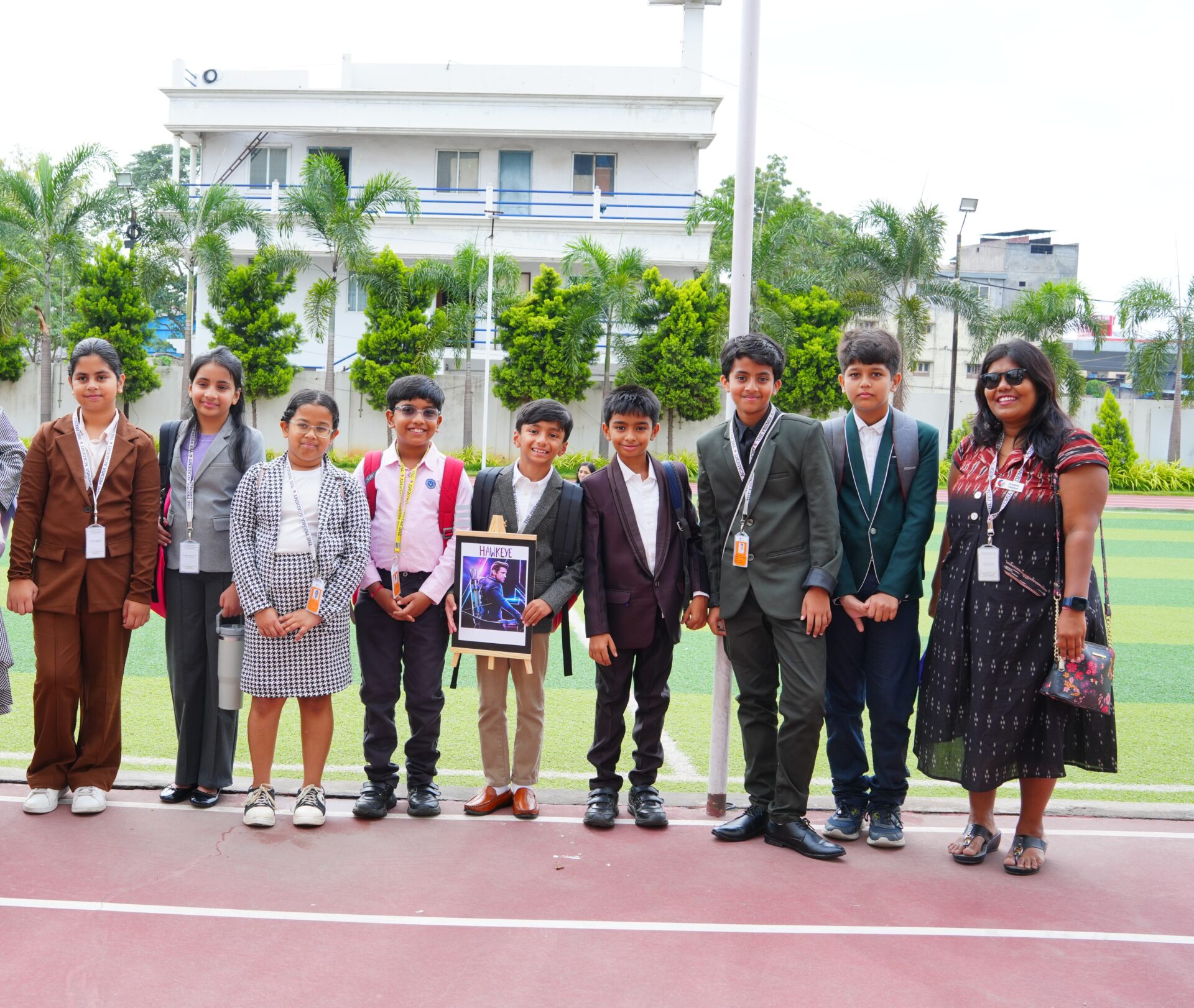 Secondary students and a teacher dressed in business attire for an event