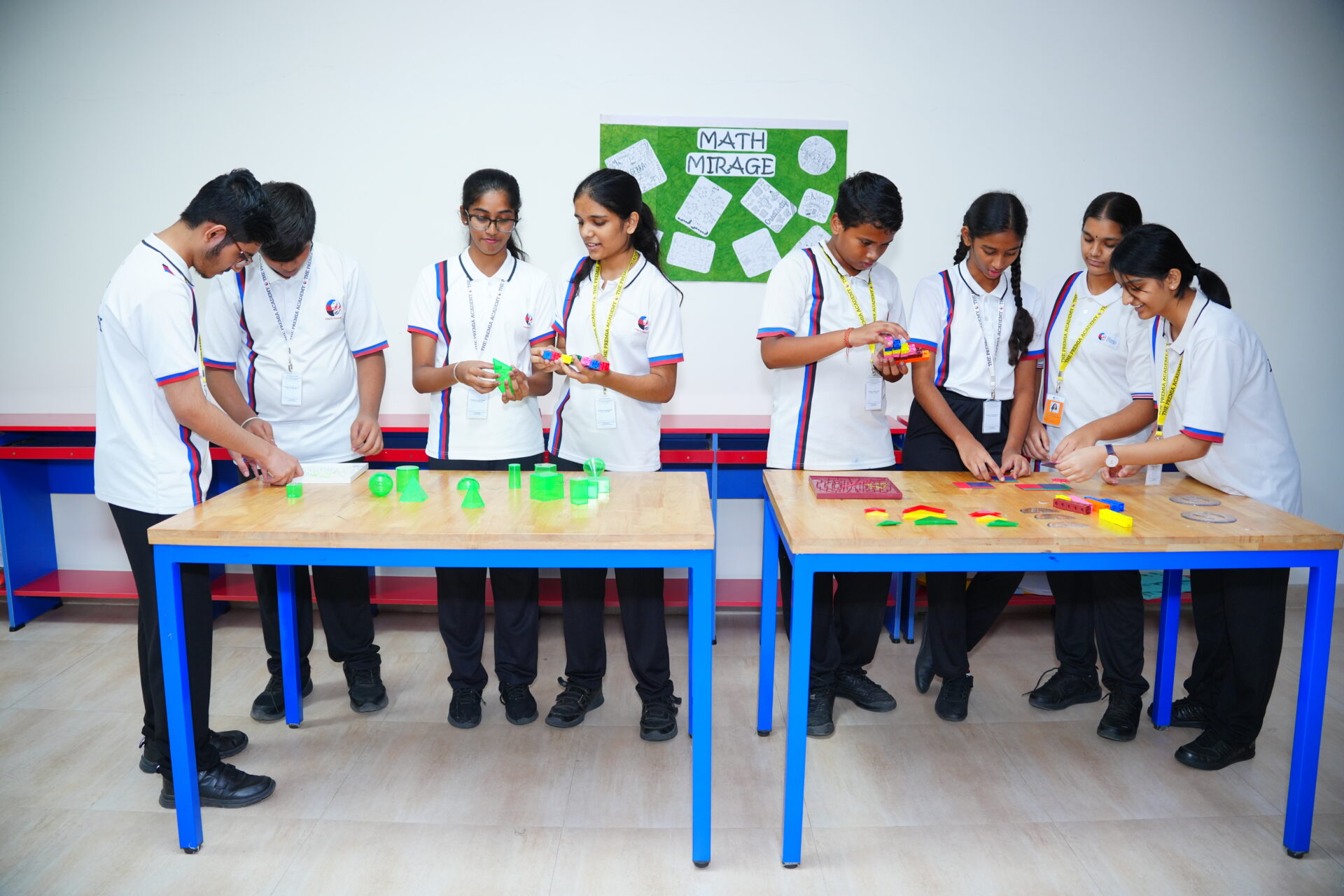 students work together with colorful geometric shapes and educational materials at a math activity table