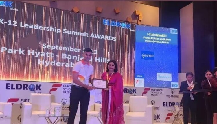 Premia Academy leader receiving a certificate on stage at the ELDROK INDIA K-12 Leadership Summit AWARDS in Hyderabad (September 2023).