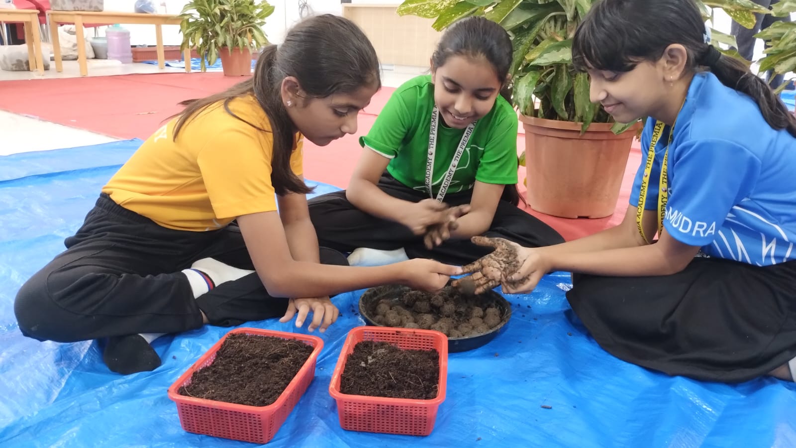 students make seed balls with mud and soil during a hands-on activity