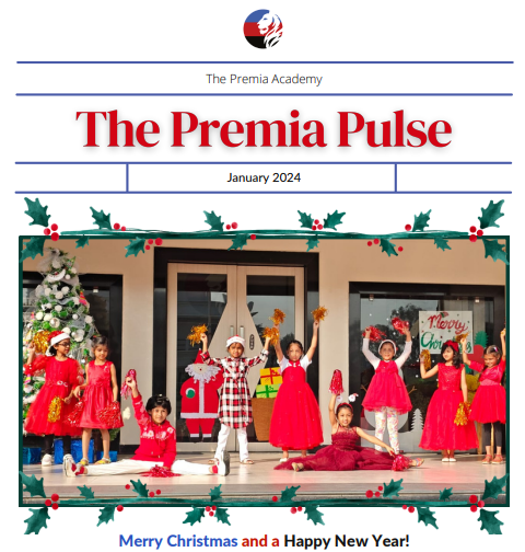 primary students performing a Christmas holiday dance on the decorated stage