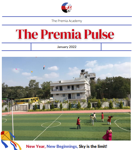 students flying kites on the school synthetic turf sports field