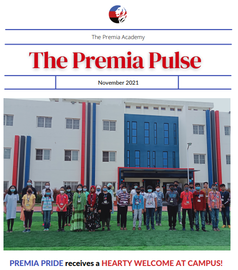 The Premia Academy, Hyderabad, students standing on the green sports field in front of the school